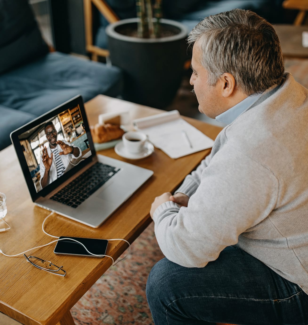 Man sitting at a desk looking at a computer