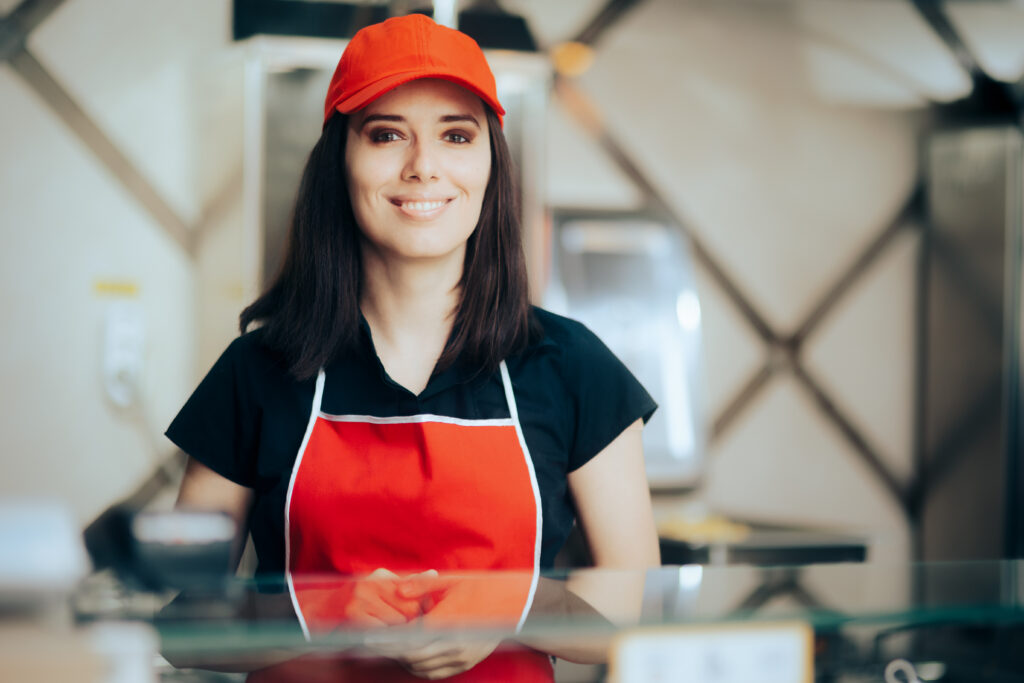 A restaurant employee greets customers.