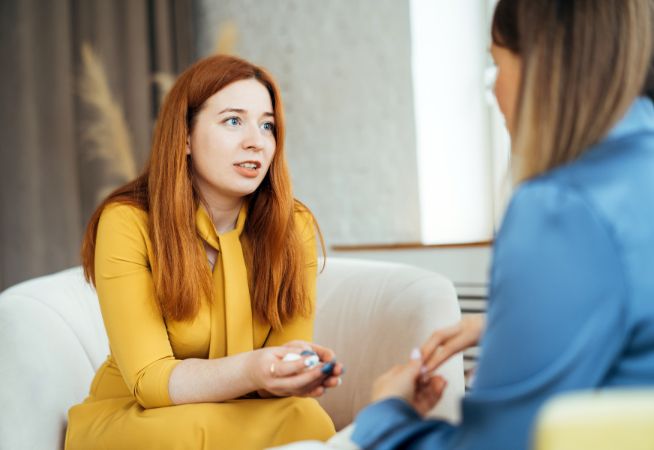 A woman speaks with an HR professional about a concern.
