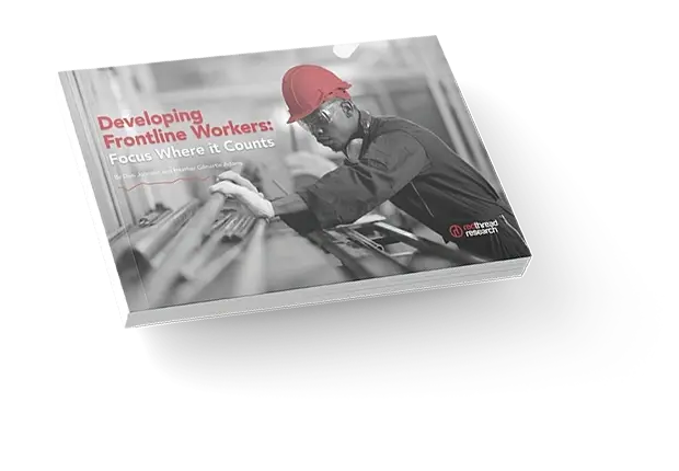 A booklet titled 'Developing Frontline Workers' with a person in a red hard hat working.