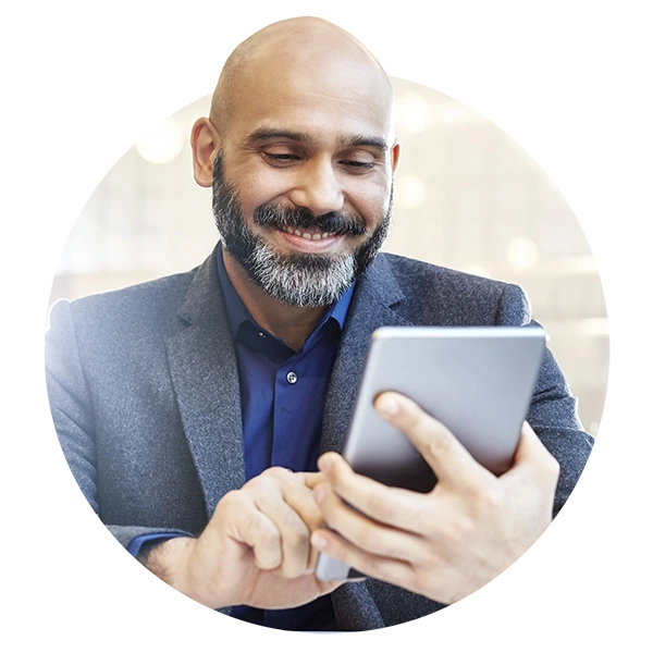 Smiling professional using a tablet for online training