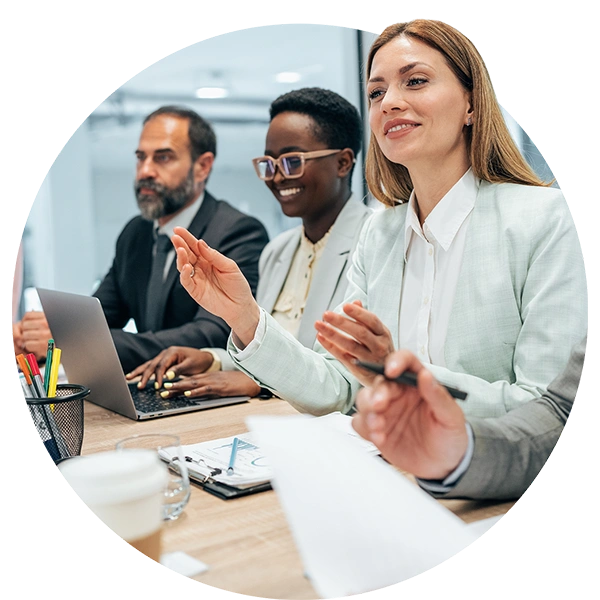 Team of professionals collaborating in a meeting with laptops and documents