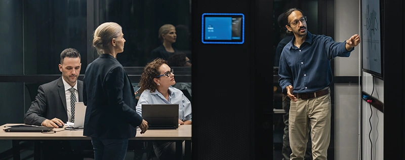 Professional presenting data on a screen to colleagues during a meeting