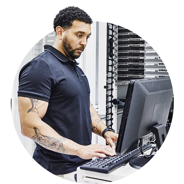 IT professional working at a computer in a server room
