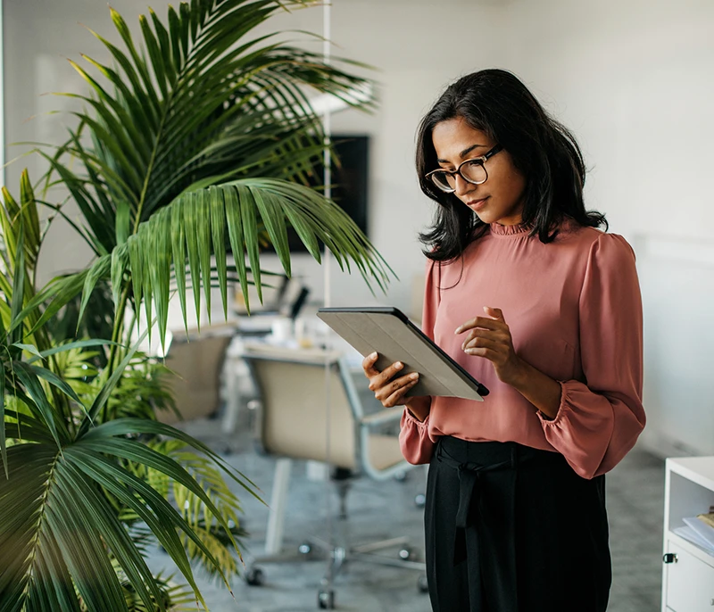 Business professional using a tablet in a modern office
