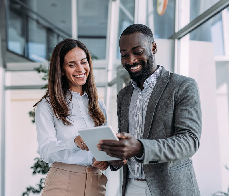 Two business professionals reviewing information together on a tablet