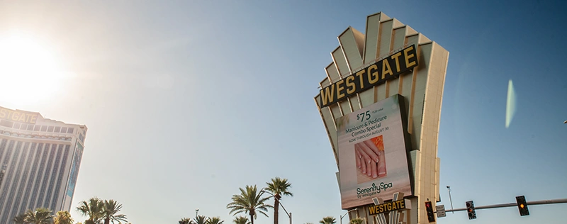 Westgate resort sign with palm trees under a clear sky
