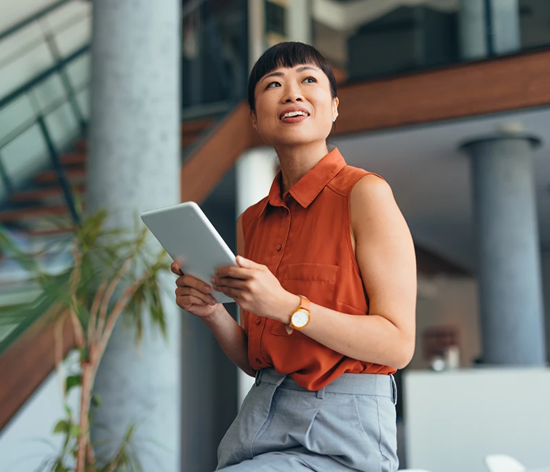 Business professional holding a tablet in a modern office