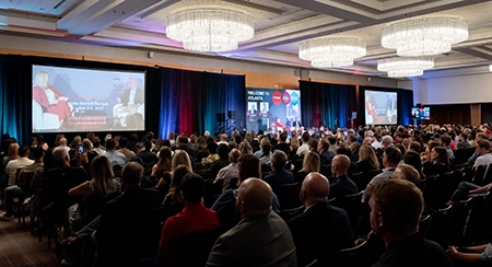 Audience attending a keynote presentation at a business conference